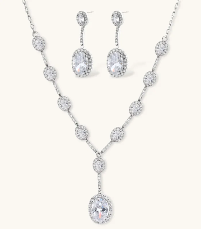 Elegant white gold plated jewelry set with oval cubic zirconia stones in halo settings, featuring Y-necklace and drop earrings.