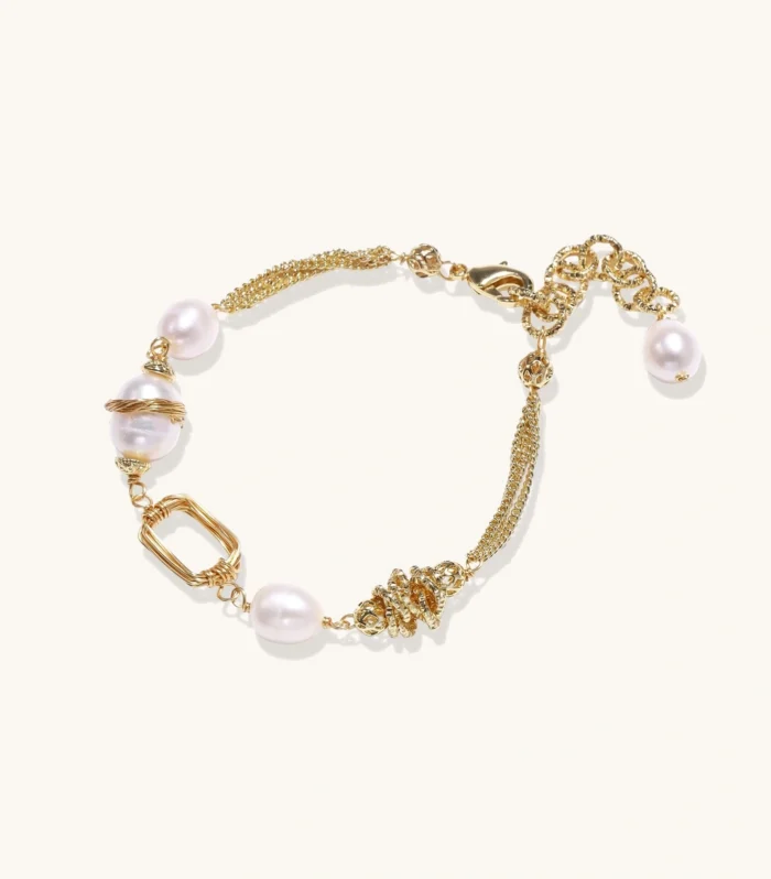 14K gold plated bracelet with freshwater pearls, filigree details, and mixed geometric elements on white background.