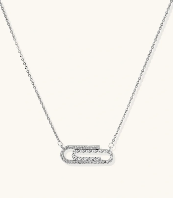 White gold plated necklace with dual-frame geometric pendant featuring crystal pavé border on pale background.