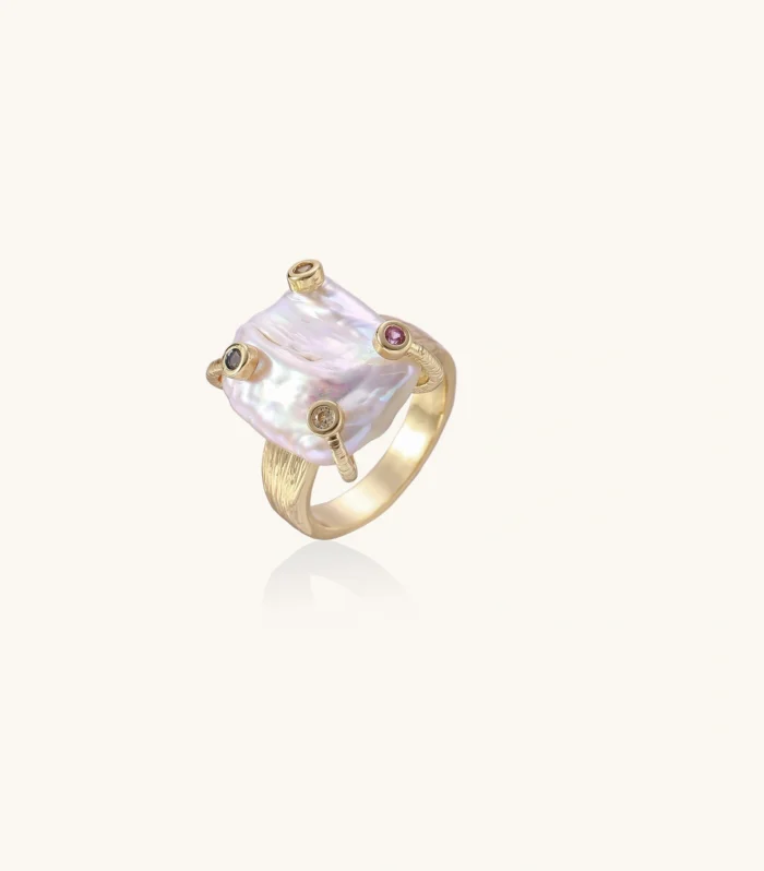 Gold ring with large iridescent baroque pearl and four colored gemstones on textured band